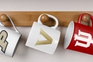 Three Mugs hanging with college logos on them
