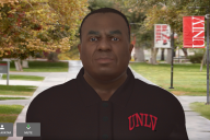 A screen shot of an AI avatar of a Black man on a college campus.