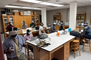 Morehouse College students utilizing the meta headsets in a microbiology class. 