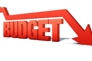 A graphic featuring a red arrow moving in a downward direction atop the word "BUDGET."