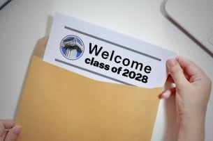 A page in a manila envelope reading “Welcome Class of 2028”
