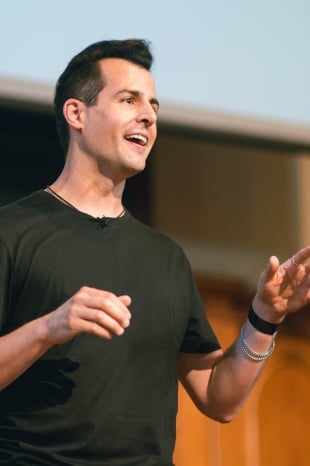 David Malan, a light skinned man with short dark hair wearing a T-shirt, a couple of bracelets, and a smartwatch