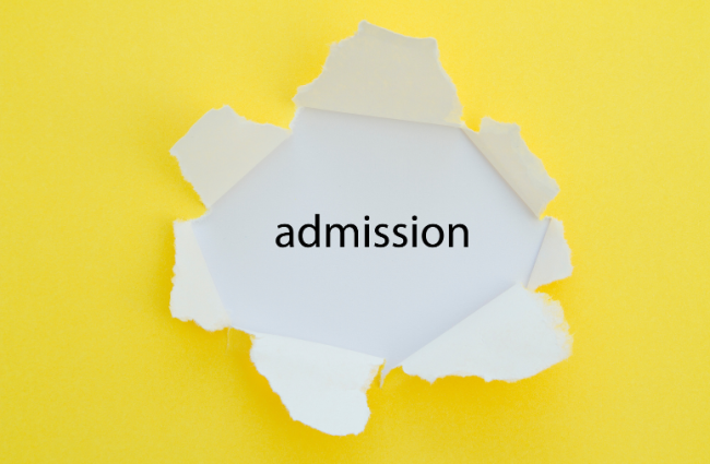 The word "admission" on a cut-out piece of white paper against a yellow background.
