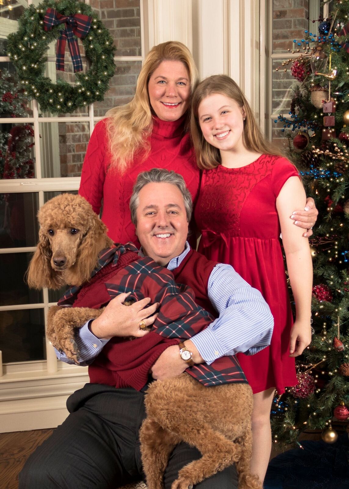 Photo of Lyon College president W. Joseph King and his family in a holiday card, in which King is holding the family dog.