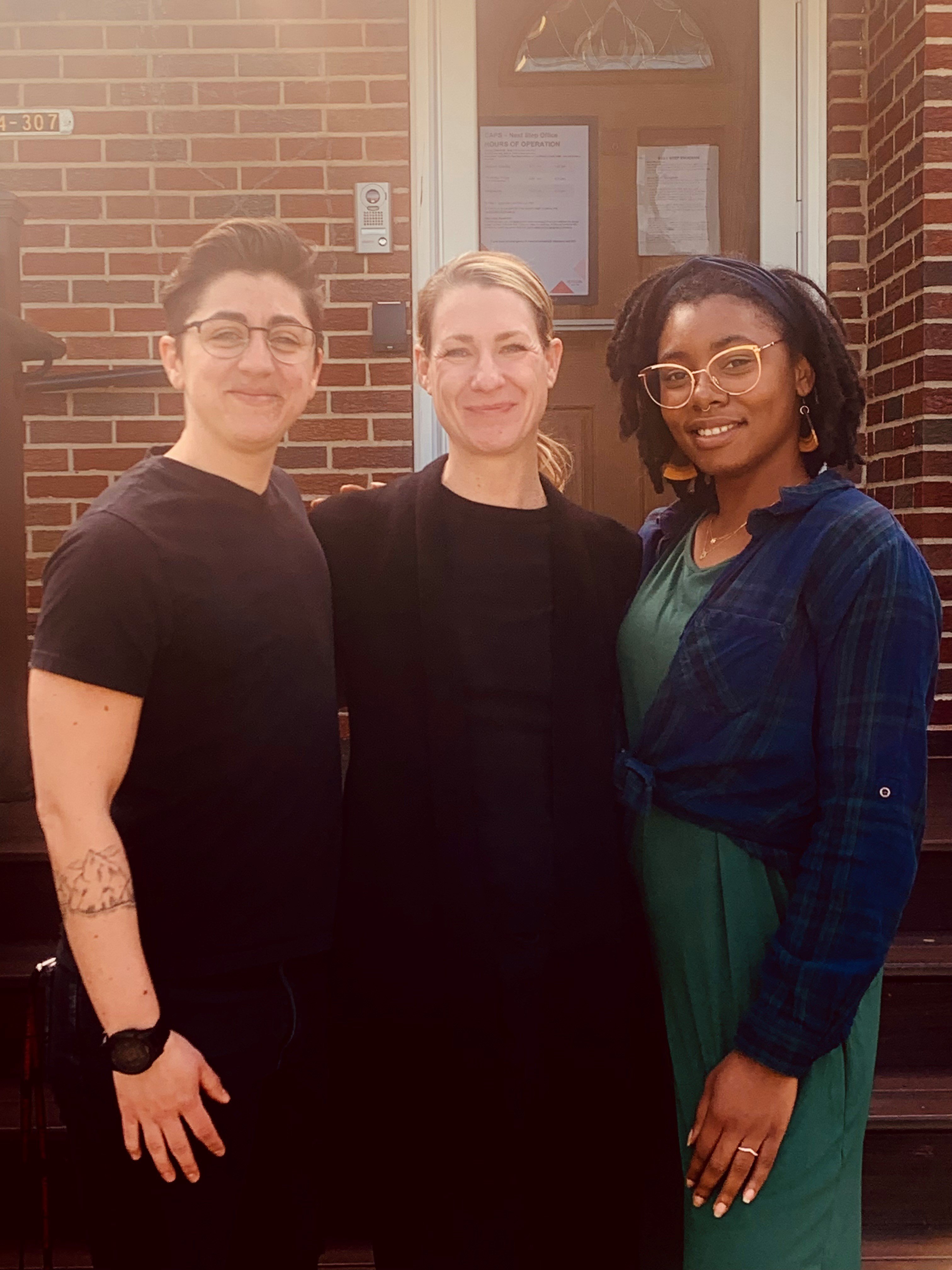Next Step staff Zan Haggerty, a light-skinned person with short dark hair; Joyce Darakcioglu, a light-skinned woman with blond hair; and Jhonel Richards, a dark-skinned woman with shoulder-length locs and glasses, smile for a photo.