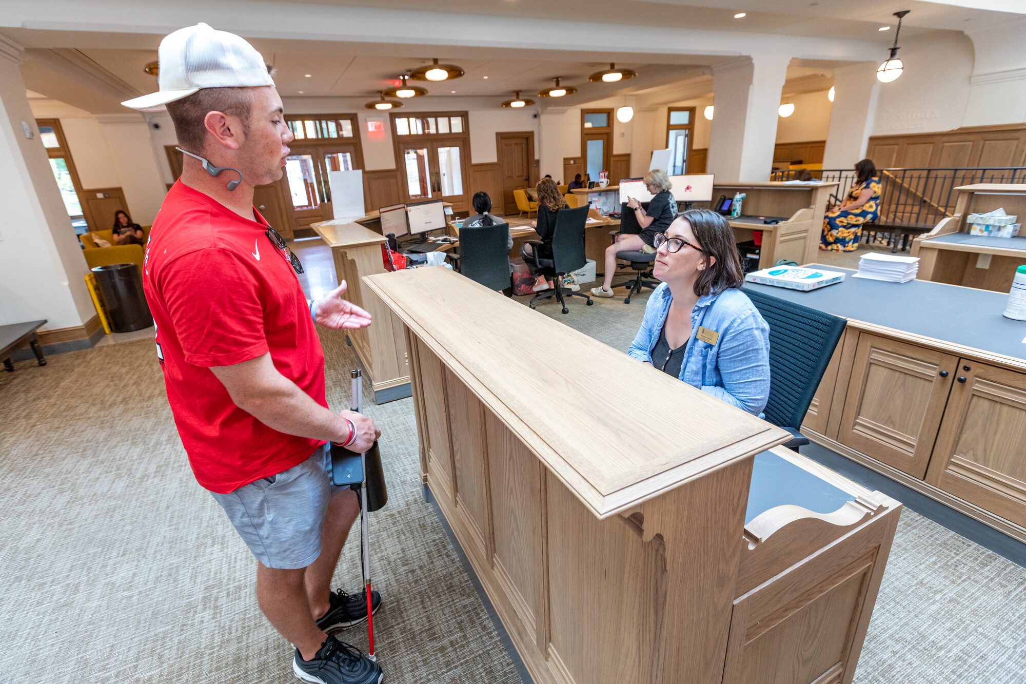 A student employee assists another student at the CORD help desk.