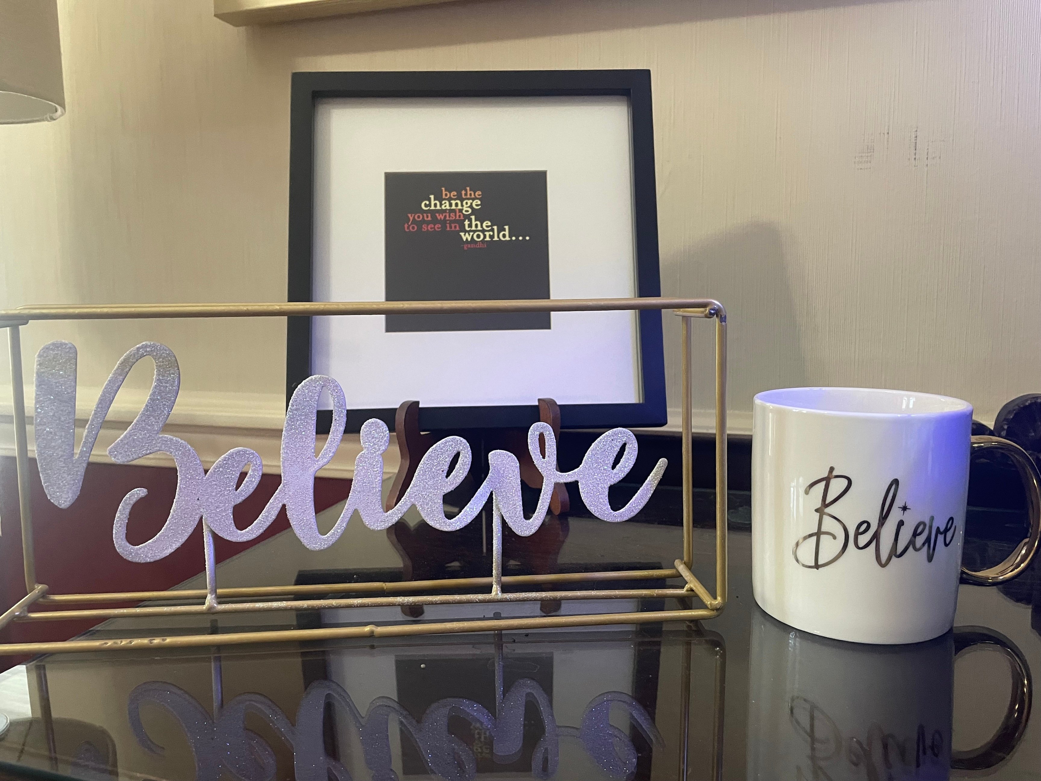 Signs that say Believe on a desk
