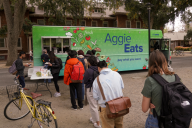 Students line up to receive a meal from the AggieEats food truck.