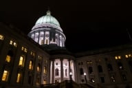 A state capitol building lit up at night