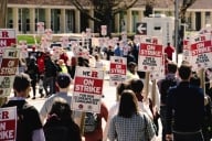 A photograph of striking Rutgers University workers holding signs.