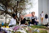 Students sit on the lawn at Marymount University in Virginia on a sunny day