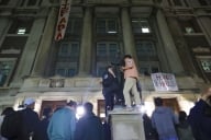 Protesters stand in front of a building they've occupied at Columbia
