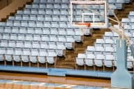 A basketball hoop in an empty stadium.