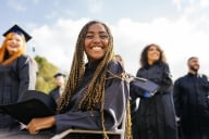 A graduate smiles from her wheelchair.