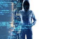 Mysterious cyberhacker with obscured face standing before a screen with futuristic blue digital code