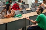 A UNT staff member talks with a prospective transfer student at Eagle for a Day