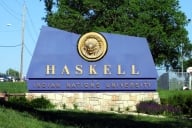 A blue sign reads "Haskell Indian Nations University" in gold letters