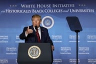 Donald Trump stands at a podium in front of a blue backdrop that reads "White House Initiative for Historically Black Colleges and Universities"