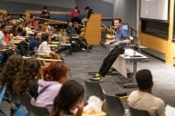A photograph of Simon Cullen, an assistant teaching professor at Carnegie Mellon University, teaching a class.