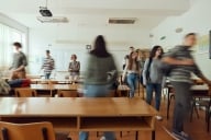 A group of college students move in motion blur before class.