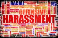 A word cloud featuring words associated with harassment. The word “harassment” is largest and in the center. Other prominently featured words (among dozens) include “offensive,” “racial,” “bullying,” “aggressive,” and “threatening.”