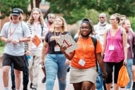 Students follow a campus tour guide at Campbell University