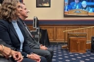 Man and woman sitting in a legislative committee hearing