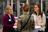 A Scripps Research alumna networking with two trainees