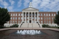 A campus building at Southern Methodist University fronted by a fountain.