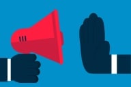 An illustration of a large hand being held up in front of a loudspeaker, seemingly as if to stop the person using the loudspeaker from speaking.