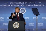 Donald Trump stands at a podium in front of a blue backdrop that reads "White House Initiative for Historically Black Colleges and Universities"