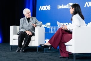 Representative Virginia Foxx and Axios reporter Erica Pandey sit in white chairs in front of a blue background that says Axios and LinkedIn, the event's sponsors.