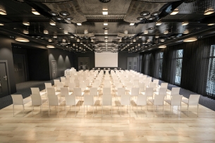 Huge, glossy conference room with dozens of empty chairs