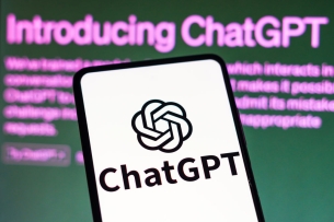 A drawing of a mobile phone with the "ChatGPT" logo in front of a dark screen with "Introducing ChatGPT" typed in purple text.