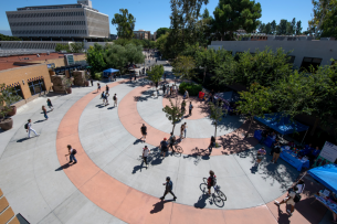 Students walk around on the University of California, Irvine, campus