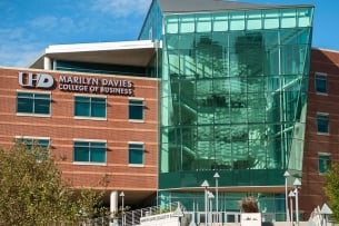 A picture of a brick and glass building with Marilyn Davies College of Business on the side.