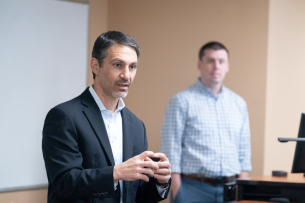 Charles Apigian speaks at a lecture.