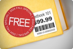 A photo illustration of a sticker saying "FREE 2024 Fall Special" on a textbook with a $99.99 price tag.