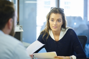 A young professional speaks with an older man.