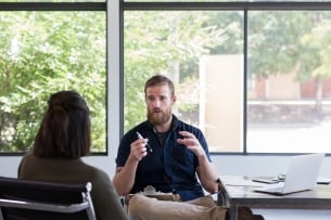 A male counselor speaks with a female client.