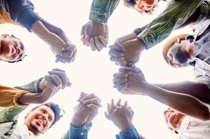 Cropped shot of a group of friends holding hands