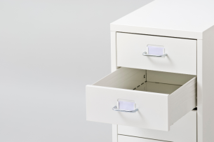 An open drawer in a filing cabinet.