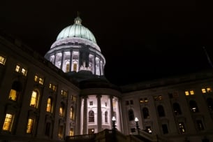 A state capitol building lit up at night