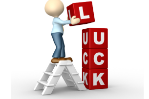 A drawing of a faceless figure atop a ladder adding the top block to a vertical stack of alphabetical blocks that spell out "LUCK."