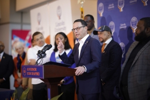 Pennsylvania governor Josh Shapiro speaks from a podium at Lincoln University