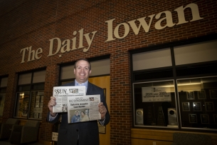 Jason Brummond holds copies of the Solon Economist and the Mount Vernon-Lisbon Sun.