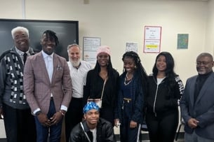 Students at South Carolina State University stand smiling with Meir Muller and Devin Randolph. 