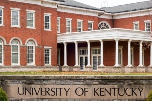 A photo of the University of Kentucky campus, showing the university’s name on a stone sign.