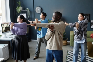 Multiethnic group of cheerful people enjoying stretching exercises