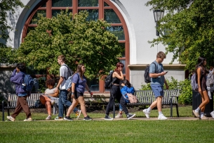 Students walk on Montclair State University’s campus on a sunny warm day